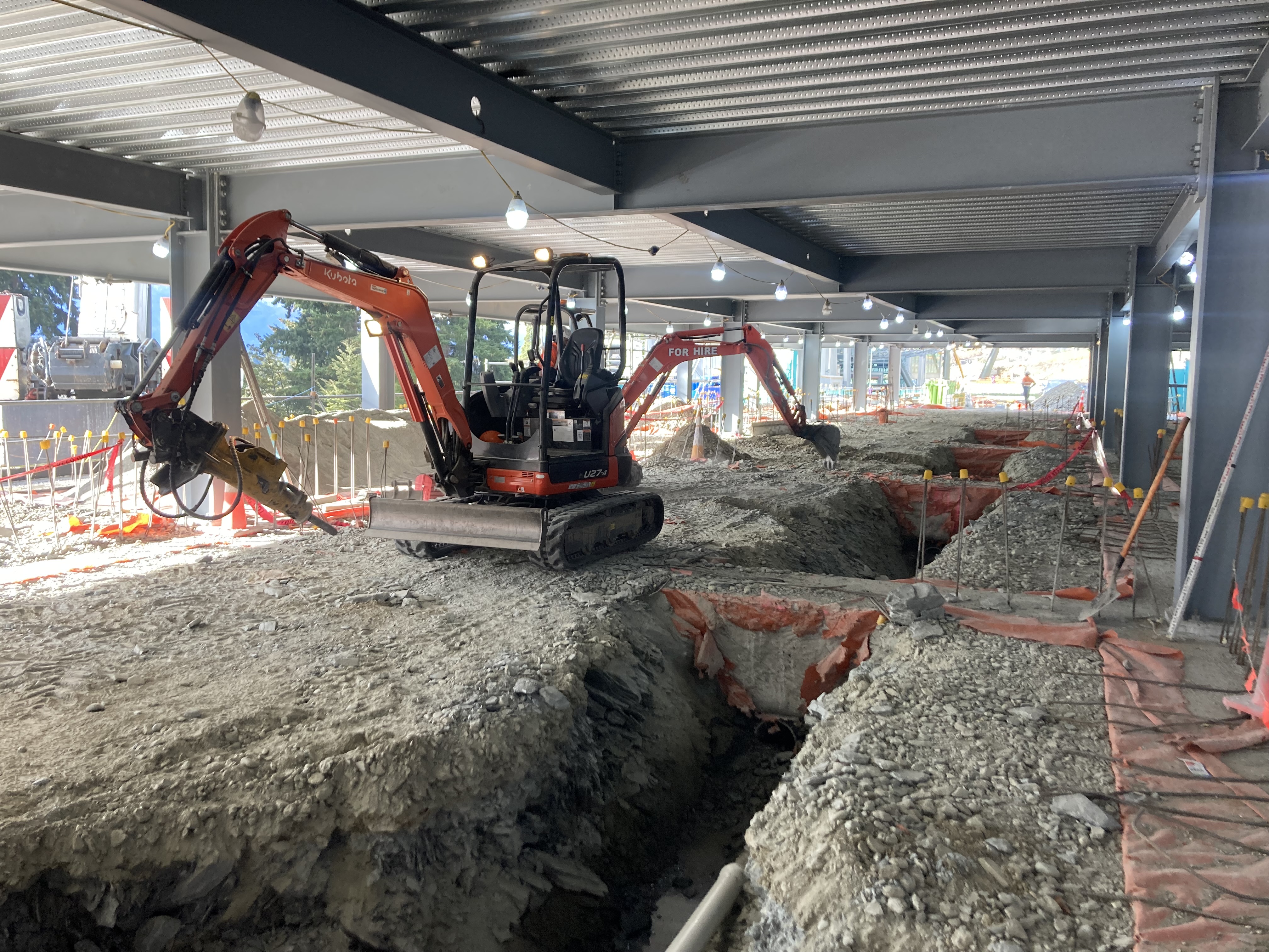 Hire South Kubota U27 digger with rock breaker attachment working inside a commercial building under construction